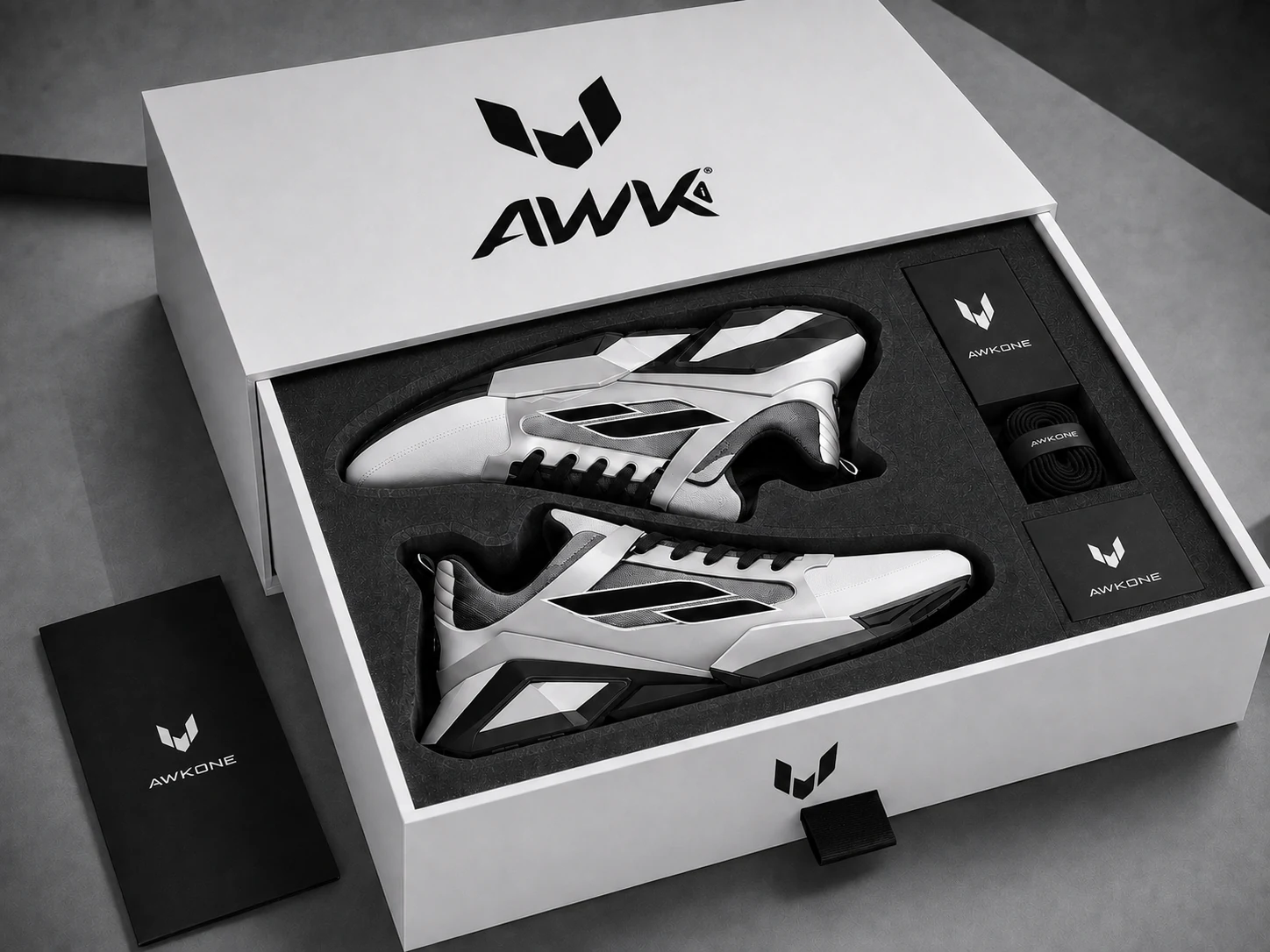 Open AWKONE presentation box with a numbered sneaker pair, edition materials and accessories